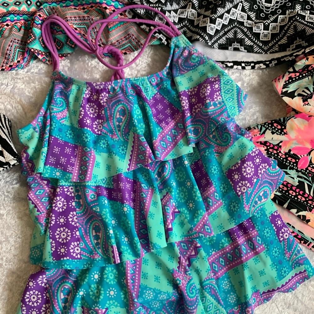 Lot of girls medium swim tank is and tops and one swim cover up. See pics